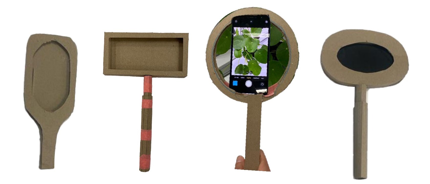 Four cardboard magnifying glass prototypes with different handle and frame shapes, one holding a phone